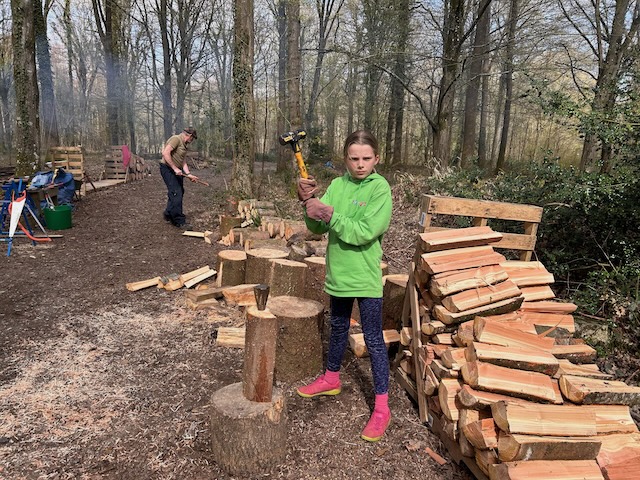 young girl chopping wood